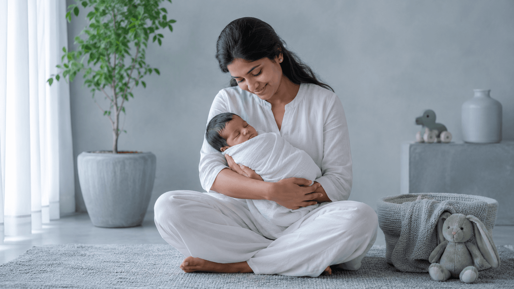 Mother holding her newborn in soft light